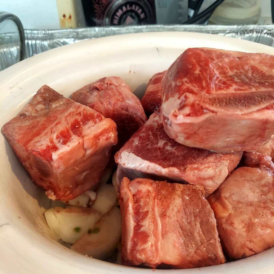 Beef short rib stew ingredients in the slow cooker