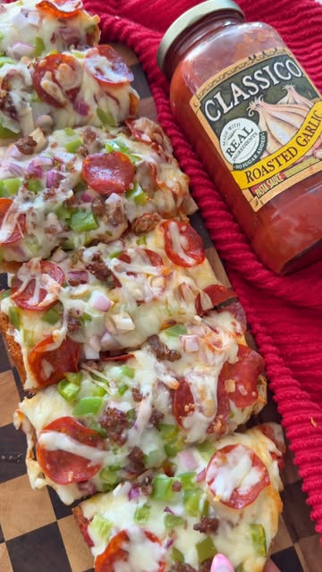 Garlic Bread Pizza with Roasted Garlic Sauce, Sausage, Mozzarella, Peppers, Onion, and Pepperoni